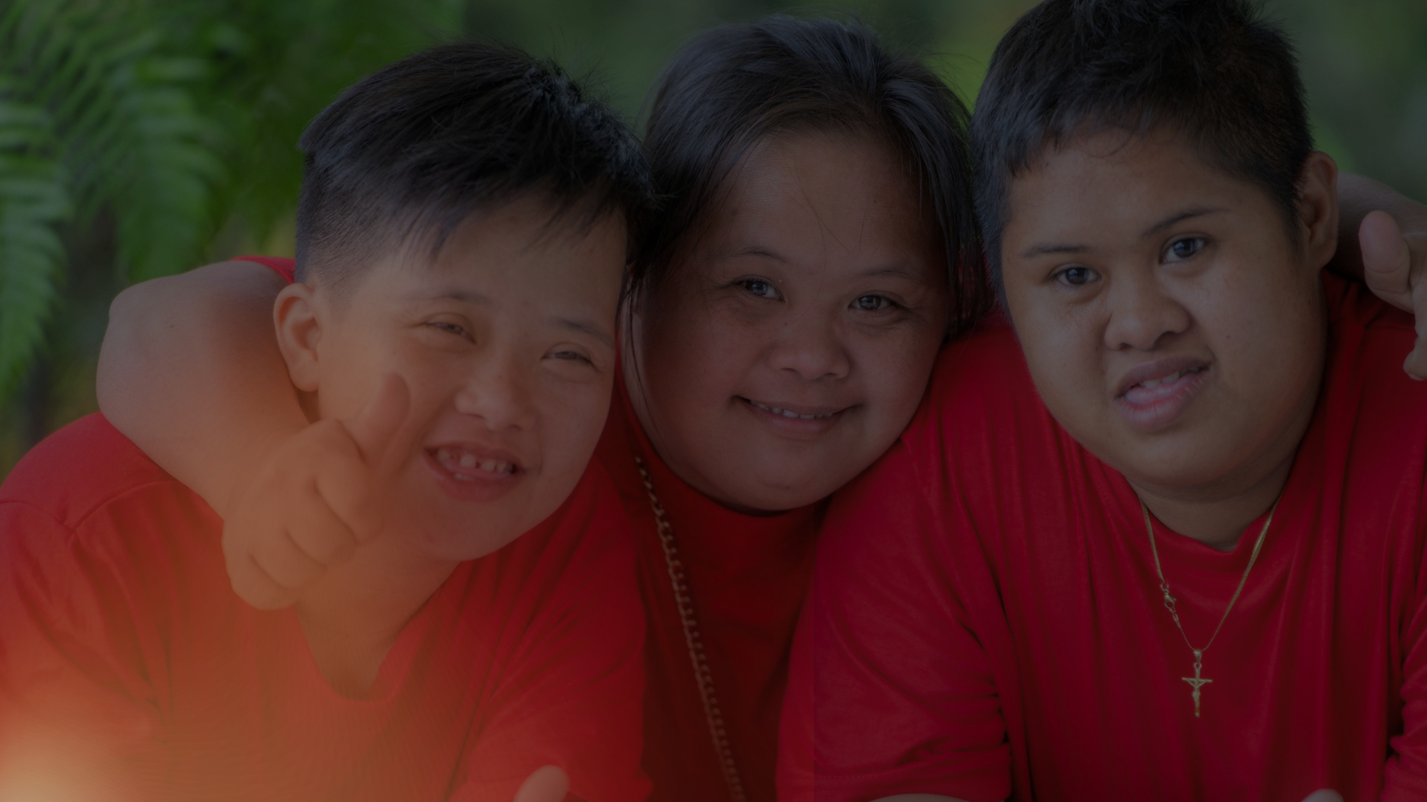 A child with Down syndrome smiling in golden light